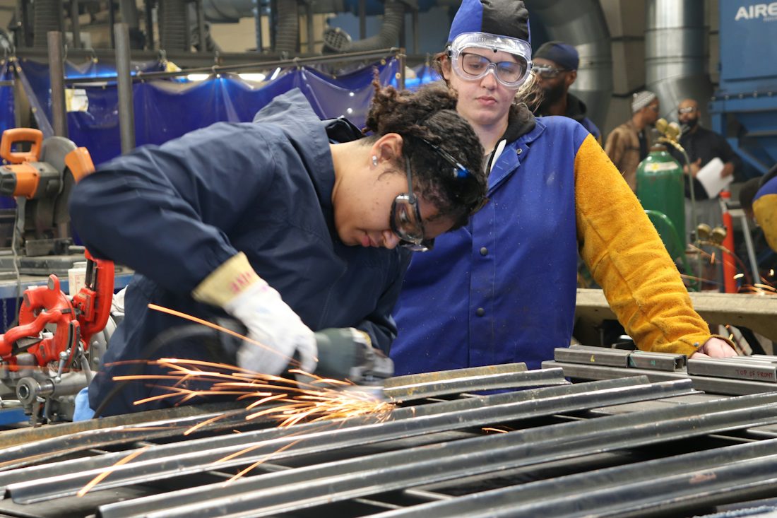 Apprentices welding in a training workshop