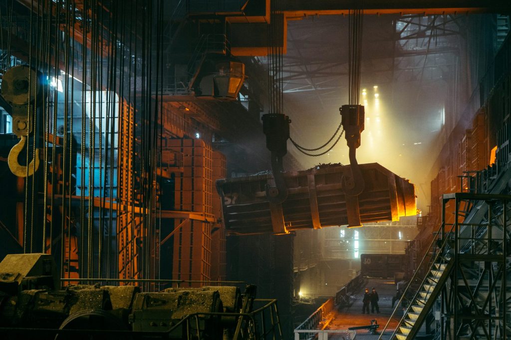 Crane lifting a glowing ladle in the melt shop