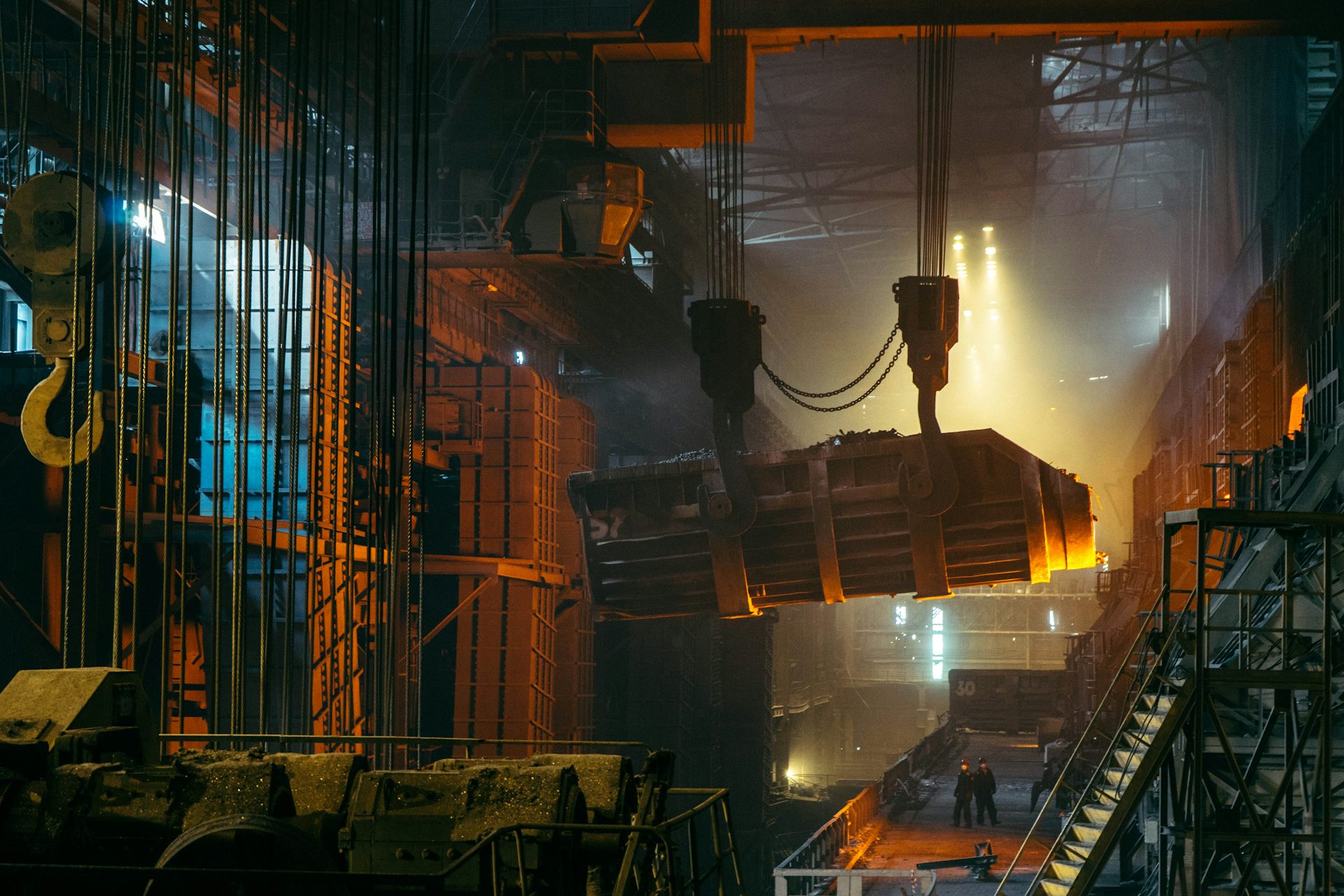 Crane lifting a glowing ladle in the melt shop