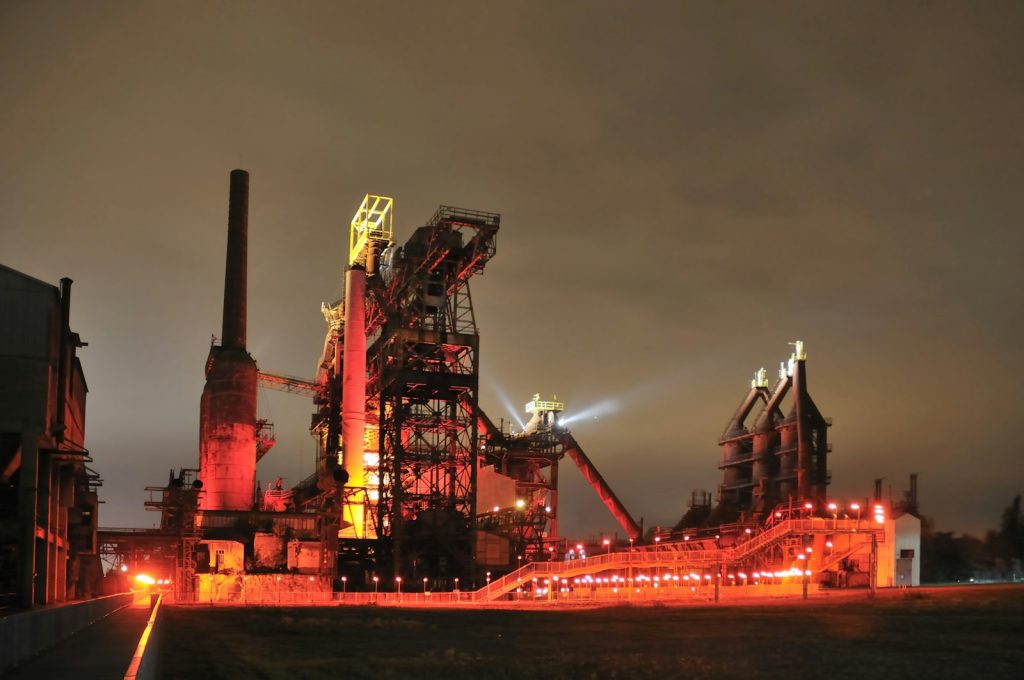 Steel plant lit red at night